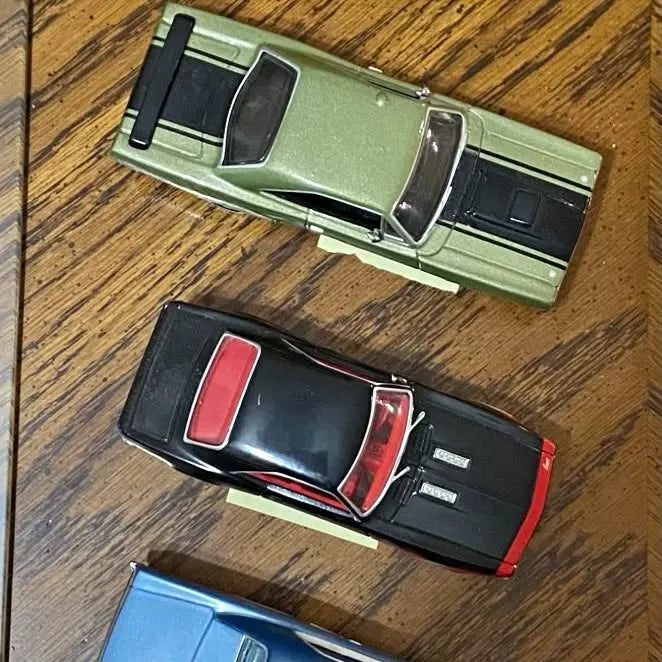 Mini diecast car set with green, black/red, and blue cars, open doors