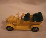 Yellow diecast model car with black wheels and black engine covers