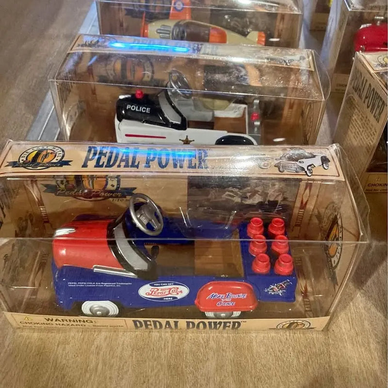 Miniature pedal car diecast in retail box, red and blue with steering wheel and small wheels