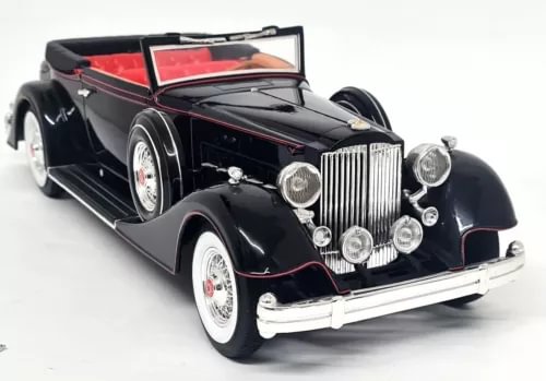 Black 1934 open convertible diecast model car with chrome grille and whitewall tires