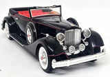Black 1934 open convertible diecast model car with chrome grille and whitewall tires