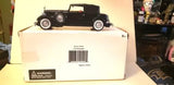 Black diecast Packard coupe model car on retail box packaging, 1:27 scale