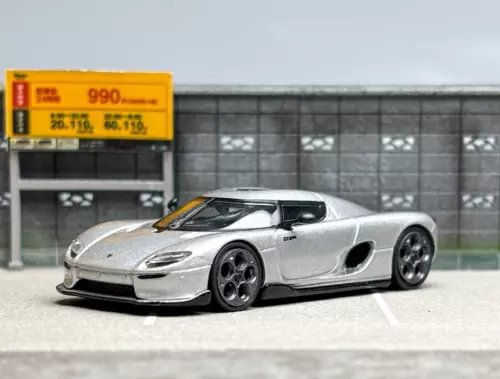 Silver diecast sports car model, detailed body and wheels, 1:64 scale toy car