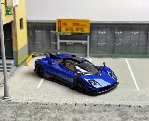 Blue sports racing model diecast car with black hood details, front 3/4 view