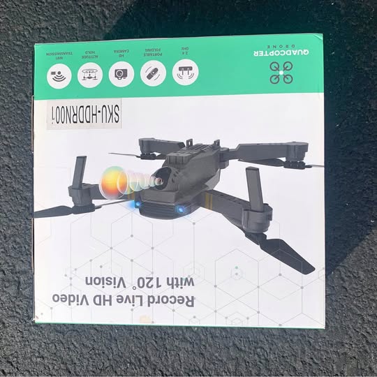 Quadcopter drone, black four-propeller model shown on product box