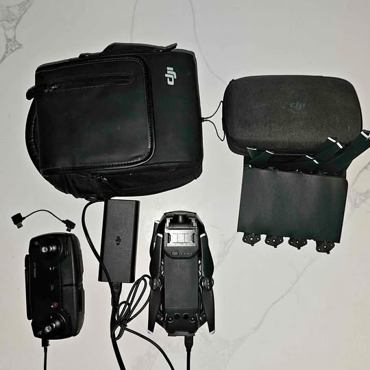 DJI Mavic Pro drone with controller, battery charger, and black carrying case