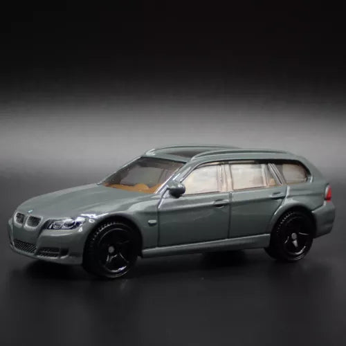 Dark green station wagon diecast model car, front 3/4 view, 1/64 scale