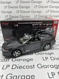 Dark gray speedster diecast model car with silver wheels and front grille