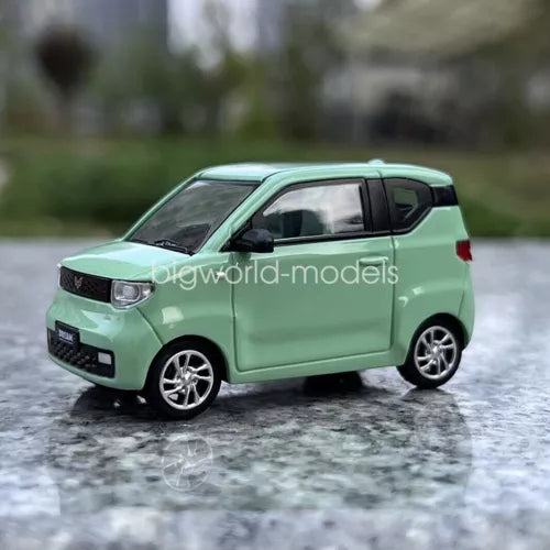 Mint green diecast mini EV car model with chrome grille and silver wheels