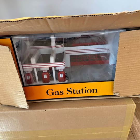 Diecast gas station set in box, with small pumps inside display window