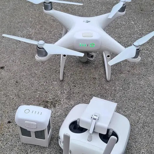 White quadcopter drone with four propellers and a white controller unit