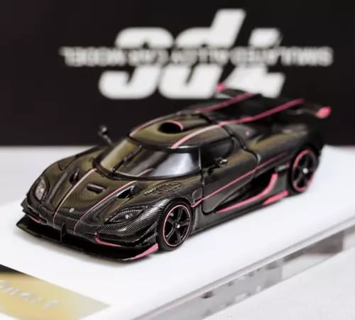 1:64 racing sport diecast model car with carbon-fiber style black body and pink accents