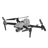 Quadcopter drone with gray body, four rotors, and front camera gimbal