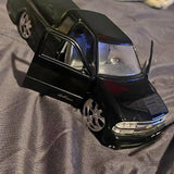 Black diecast pickup truck with chrome wheels and front grille