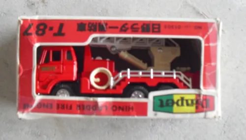 Red diecast ladder fire engine toy inside retail box with clear window