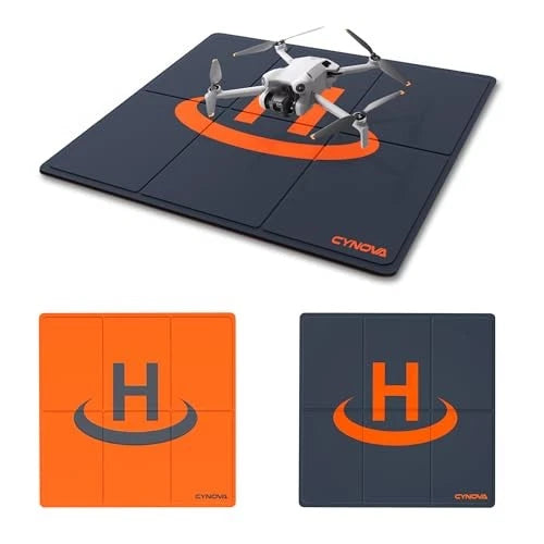 Drone landing pad with orange H logo on dark blue folding mat