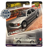 Silver 1:64 diecast Mercedes-Benz 190E car, front 3/4 view with headlights