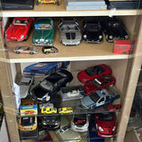 Diecast miniature car display with assorted colorful model cars in glass case