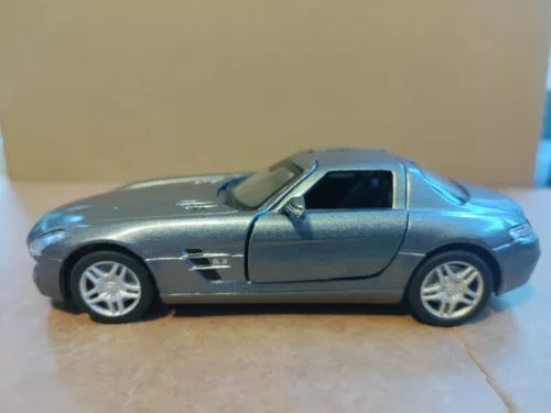 Diecast model toy car, gray with black stripe, 1:36 scale, side view.