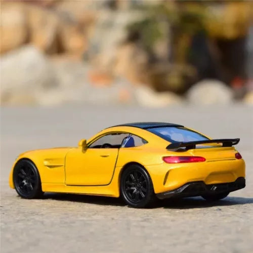 Yellow diecast sports car model with black rear spoiler and wheels