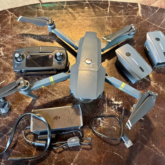 Foldable quadcopter drone with blue arms and gray body