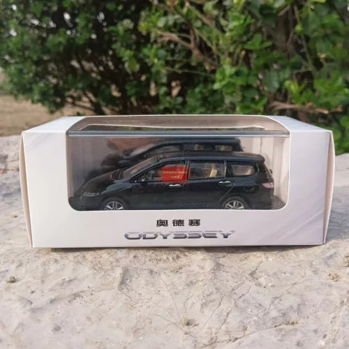 Black diecast minivan model in clear display box with printed Odyssey branding