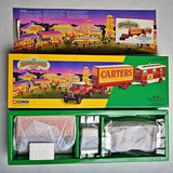 Circus truck diecast set in retail box, featuring red and yellow trucks labeled Carters