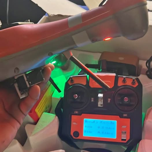 Red fishing drone remote controller with LCD screen and antennas