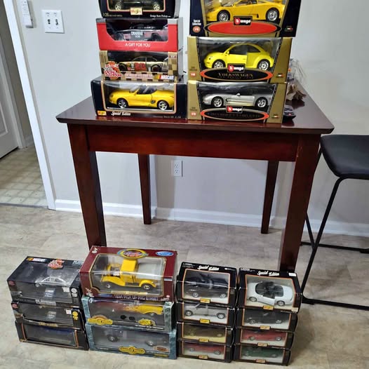 Diecast car collectible set: assorted cars in retail boxes, yellow and dark models