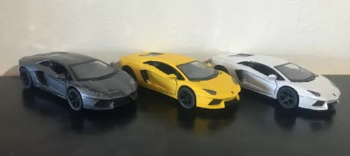 Set of three diecast sports car models: black, yellow, and silver, 1:36 scale