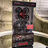 Palm-sized performance drone box with red and black quadcopter, four propellers
