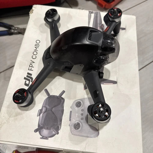 Black FPV drone with four arms and propellers on display