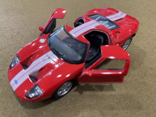 Red and white 1:36 diecast model toy car with hood open