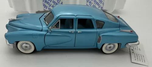 1/24 scale vintage diecast car model, light blue side profile with open wheels