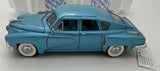 1/24 scale vintage diecast car model, light blue side profile with open wheels