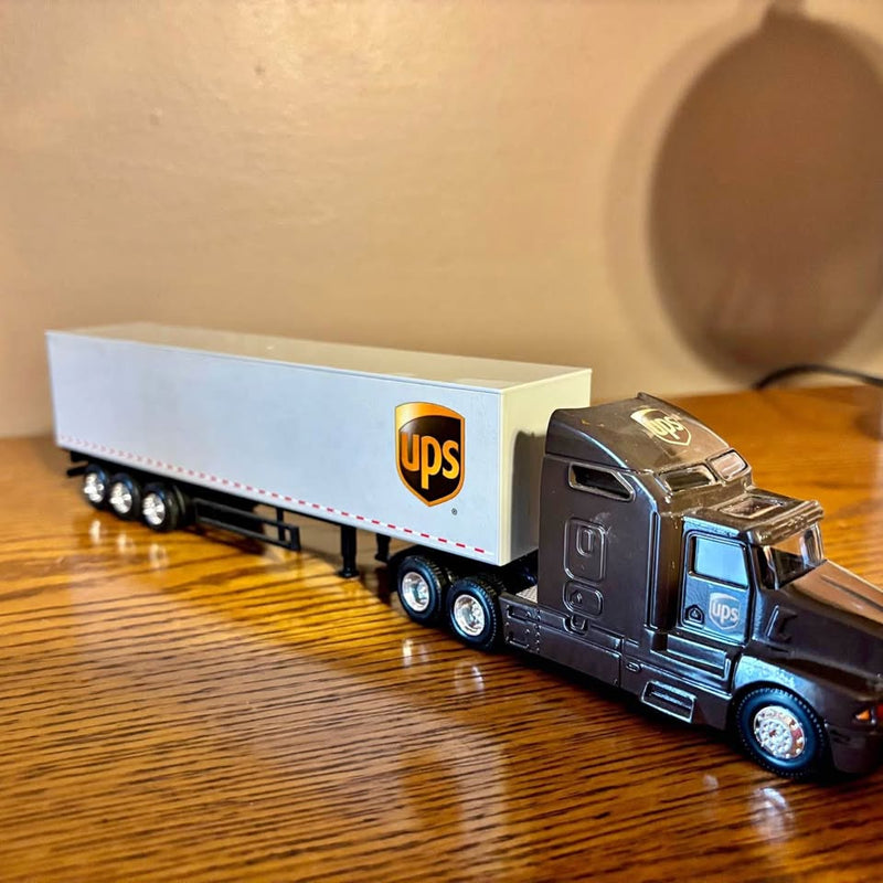 UPS diecast tractor-trailer replica with dark blue cab and white UPS logo trailer