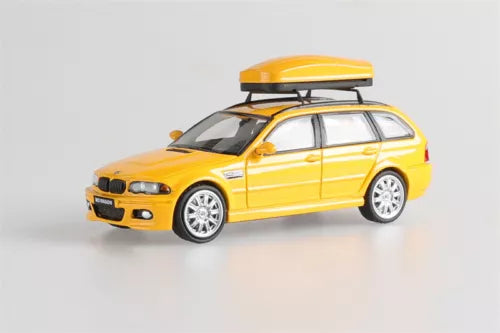 Yellow station wagon diecast model car toy, front 3/4 view with roof rack