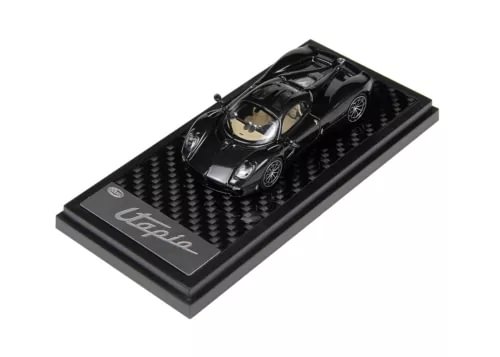 Black diecast sports car model with carbon-fiber base, 1:64 scale, front three-quarter view