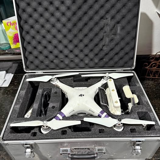 White DJI Phantom 3 drone in hard case, propellers attached