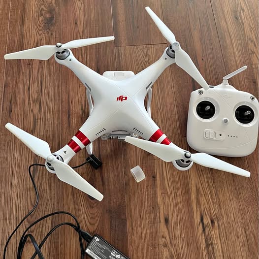 DJI Phantom quadcopter drone in white with four propeller arms and camera gimbal