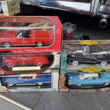 Boxed diecast car models, red and blue vintage vehicles, 1:18 scale