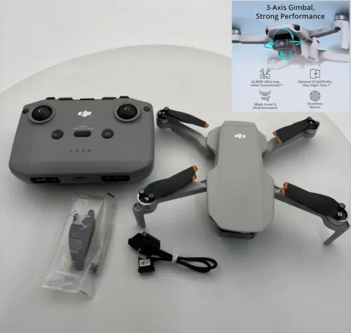 Compact drone with gray body, foldable propellers, and handheld controller with cables