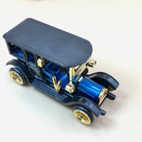 Diecast collector car with blue and black body, gold wheels and bumper detail