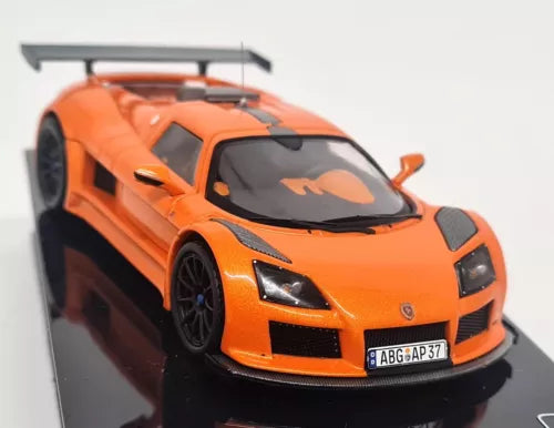 Orange Gumpert Apollo S 2010 diecast model car, front view with headlights