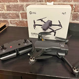 Foldable gray quadcopter drone with remote controller