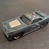 Maisto Dodge Challenger diecast toy car, dark finish with black wheels.