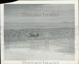 Unmanned drone press photo with camera view over desert landscape, grayscale