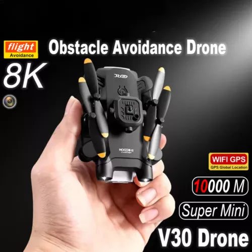 Black mini quadcopter drone with four propellers and front camera, held in hand