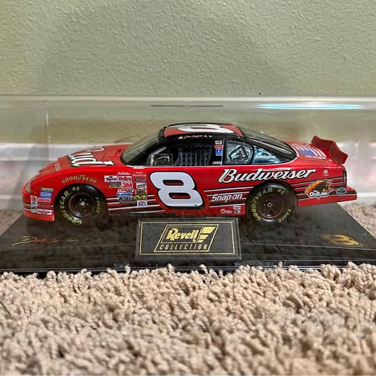 Red Budweiser NASCAR diecast car with black hood, number 8, Monte Carlo body