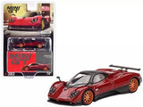 Red diecast model sports car with black accents and orange wheels, front three-quarter view